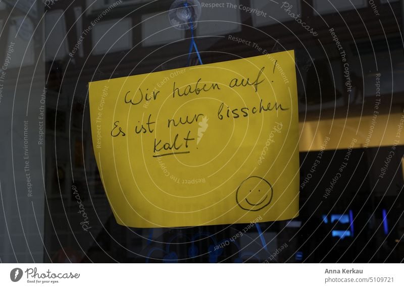 We are open! It's just a little cold! - Sign on a window pane Energy crisis Save energy Emergency solution Problem solving Climate heating costs Temperature
