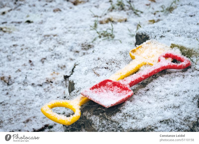 Two forgotten child shovels under the snow Playground children Shovel sand shovel Snow fresh snow Virgin snow Cold Winter Red Forget Doomed Yellow Weather