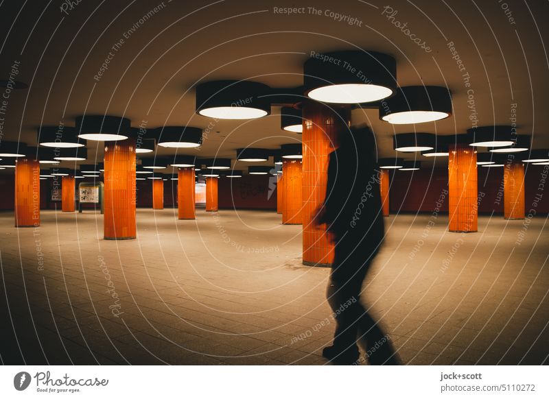 Underpass with pedestrian in orange Built Subsoil Architecture Column Retro Tile Lighting Structures and shapes motion blur Shadow Lanes & trails Tunnel Berlin