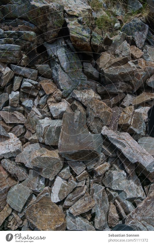 Stone formed in the shape of the letter L with many other mountain stones of the pyrenees pattern texture nature rock rough closeup detail textured natural