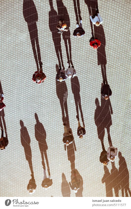 large group of people on the street, tourists in Bilbao city, spain crowd tourism person human pedestrians shadow silhouette ground outdoors urban city life