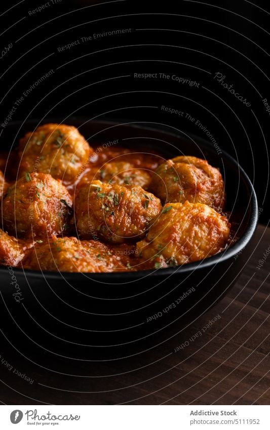 Delicious meatballs in tomato sauce food bowl delicious dish board dark cuisine tasty herb yummy meal pile wooden heap room gourmet appetizing culinary