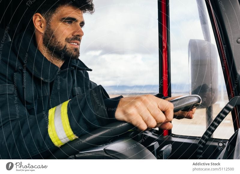 Hispanic fireman driving fire engine drive smile work emergency friendly uniform protect portrait male adult hispanic ethnic service positive professional job