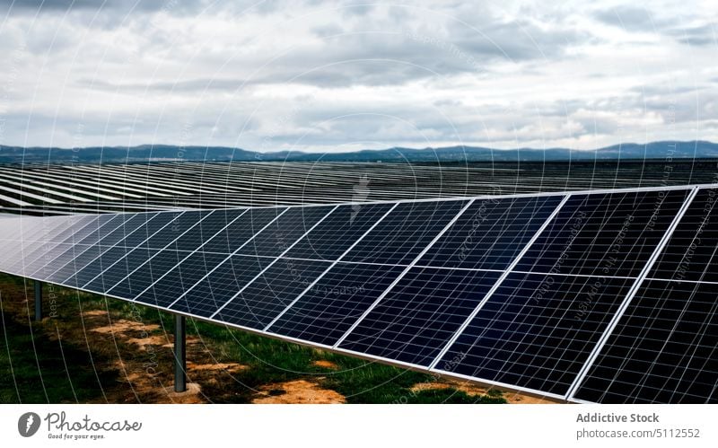 Solar panels on power station solar cloudy sky reflection shiny daytime energy electricity technology photovoltaic ecology renewable alternative industry