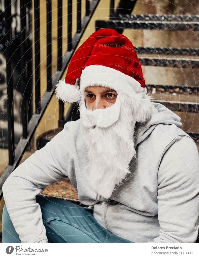 Homeless Santa drinking wine and rummaging through garbage bins alcohol alcoholic bad santa beard begging bottle brutal caucasian celebration charity christmas