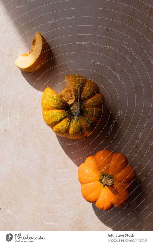 Healthy pumpkins placed on table in sunlight vegetable slice vitamin fresh food healthy food ingredient raw ripe squash tasty vegan autumn rustic plant natural