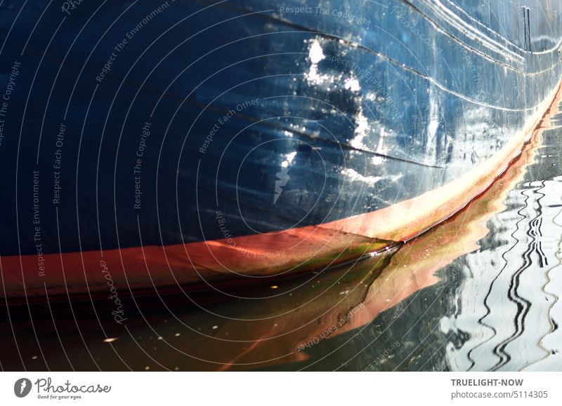 Ship wall of old barge with red marking of water line, light reflections and reflection in river ship Motor barge Barge ship's side Red Water line Contrast