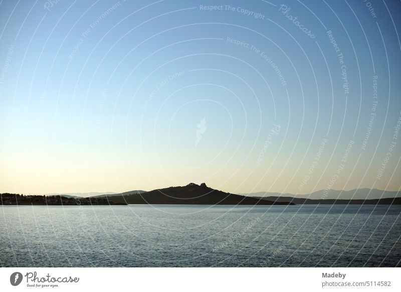 View of the sea in the light of the evening sun with coastal landscape, bay and peninsula in Cunda near Ayvalik on the Aegean Sea in Balikesir province in Turkey