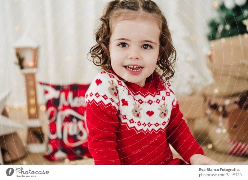 cute little girl at home during christmas time child presents happy gift cheerful 2 kid children family december decoration indoors smile adorable star santa