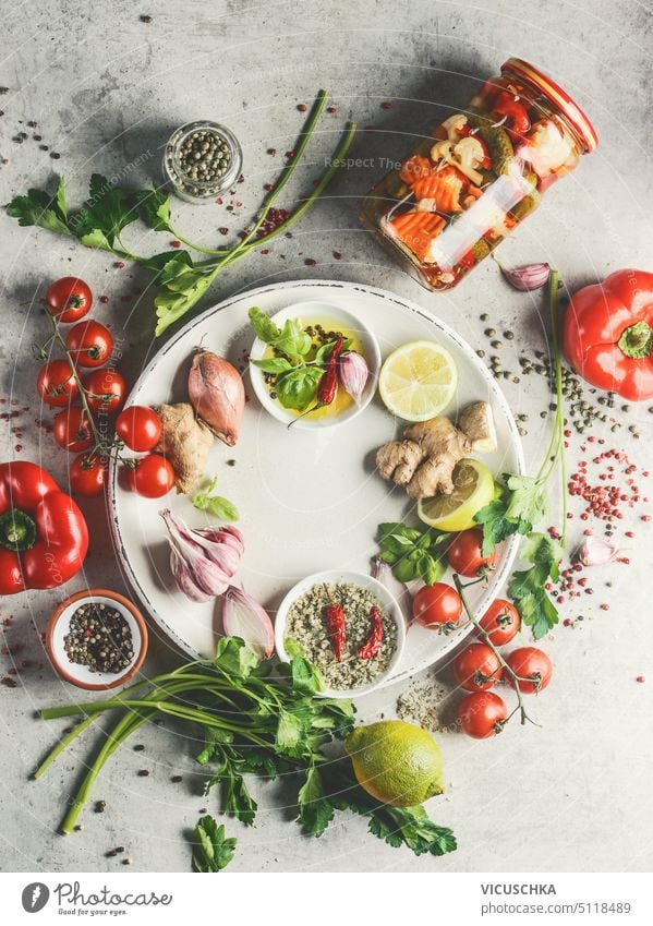 Healthy fresh flavor ingredients : lemon, ginger, onion, garlic, olive oil, herbs, salt and pepper on white plate , top view. healthy overhead frame seasoning