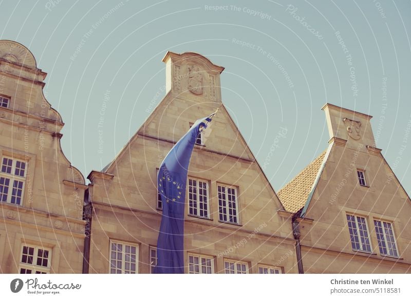 The European flag flies on one of the gabled houses on the Prinzipalmarkt in Münster Flag Sign Münster in Westphalia Building Peace Window Responsibility