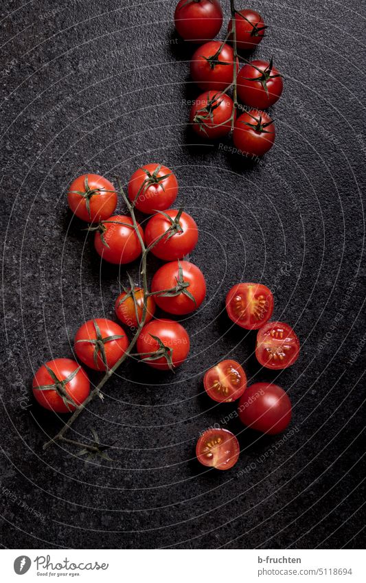 Tomatoes on a black kitchen plate Lie Kitchen Food Vegetable Nutrition Vegetarian diet Organic produce Healthy Eating Vegan diet Red tomatoes Cocktail tomato