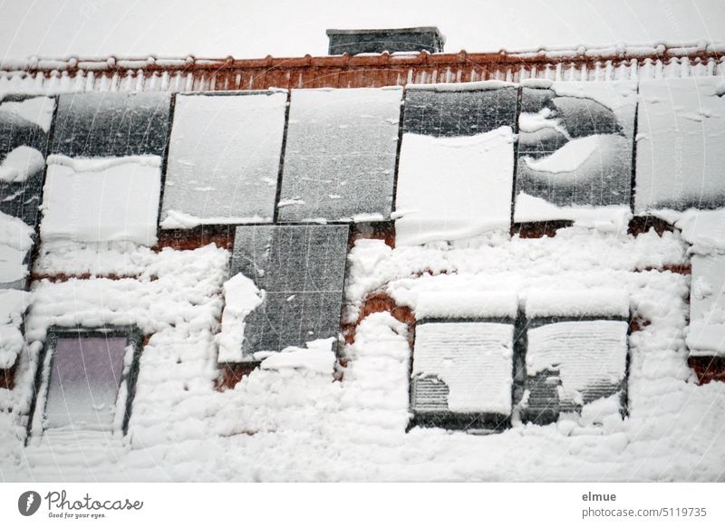 snow covered photovoltaic system on a gable roof / winter / climate change light energy Climate change Snow Power Generation Winter energy revolution Roof