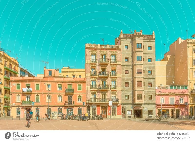 Pastel apartment buildings in the marketplace of Barcelonata catalonia Catalonia Montjuic Spain Summer vacation pastel Orange belb Turquoise Sky barcelonata