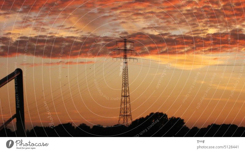 View from Weser ferry on crossing power line with extra high lattice tower in sunset lattice mast pylon Electricity pylon Transmission lines Technology stream