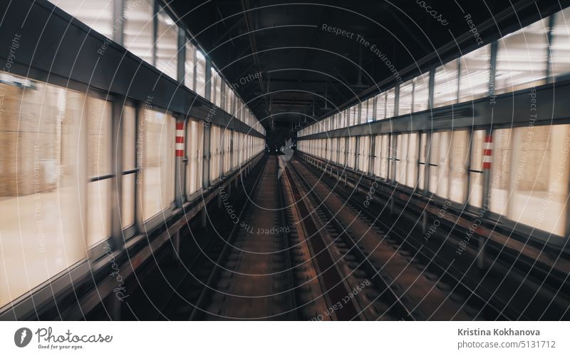 View of subway tunnel as seen from the rear window of moving train. Fast underground train departs from modern subway station. 1920x1080 background blur cab