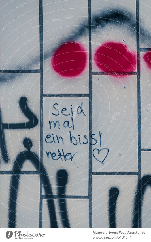 A slogan on tiles of a pedestrian underpass: "Be a little nicer". be nicer Positive saying Graffiti graffiti Underpass Train station motto Heart Love Humanity