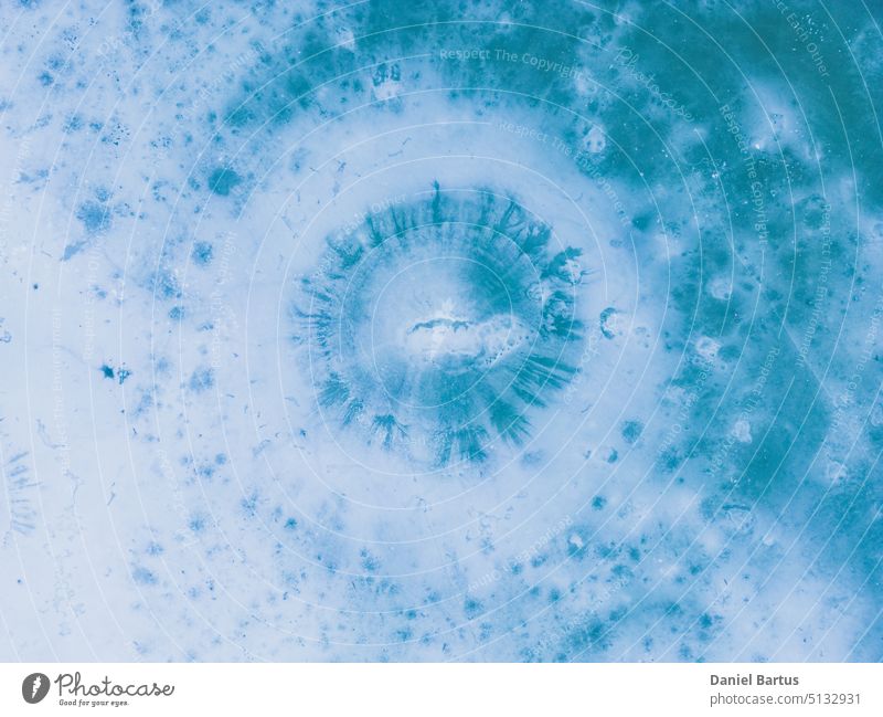 Aerial view of a frozen lake. Ice sheet background. Frozen waves on the lake. Ice background. Ice cover on a lake in southern Poland in the Bieszczady Mountains