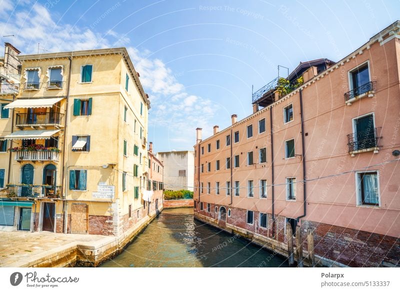 Venice city scene with a small canal laundry comacchio mediterranean outdoor pallotta arch stairway po delta park vertical photo tourists bright vivid gondola