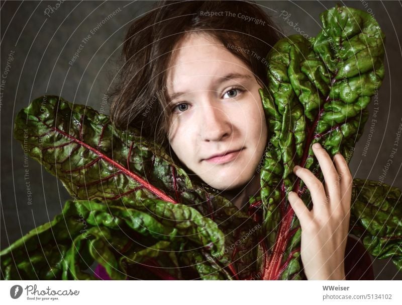 The girl clutches the beautiful large chard leaves to herself Girl Vegetable Nutrition Food Green green stuff vegetarian vegan Kitchen love Like Face Mangold