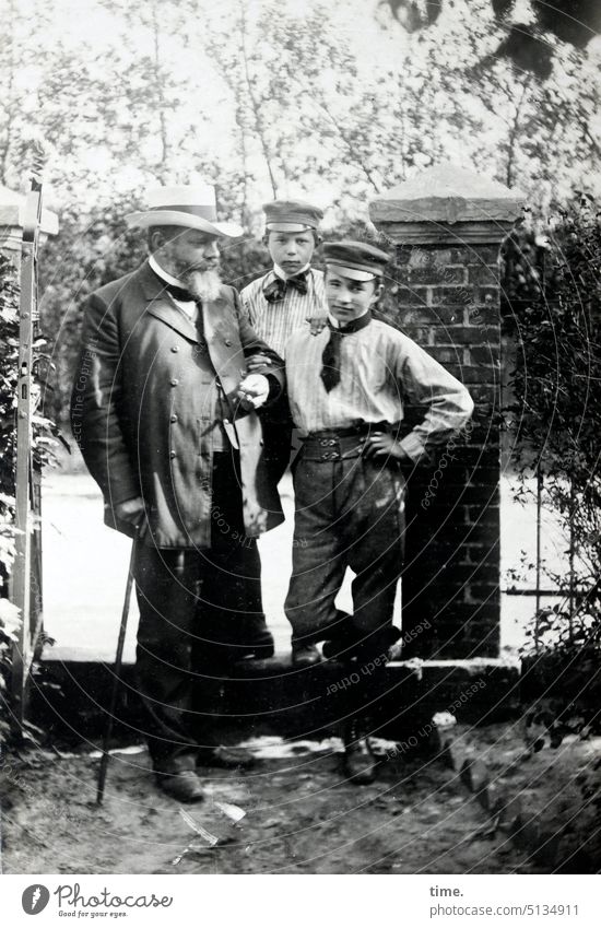 Father with two sons Man masculine portrait Historic at the same time Trust Stand Looking into the camera types Old Former then Student Peaked cap Hat