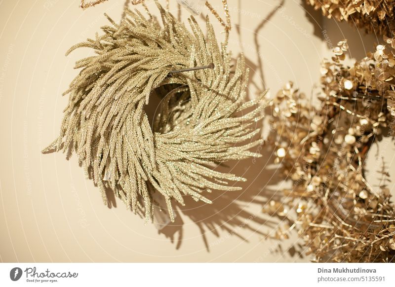 Shiny glitter shimmer golden Christmas wreath on a wall as interior holiday season decoration shiny luxury background christmas business marketing celebration