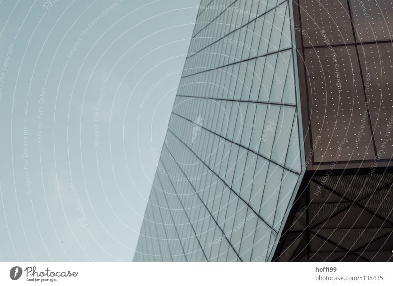 Corner and glass facade of modern architecture against gray cloudy sky Glas facade Facade Glass Modern Building Reflection reflective High-rise Office building