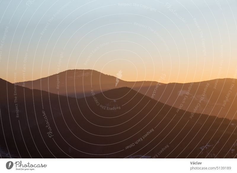 Last rays of the sun illuminating the mountainsides with orange light. Ostravice, Beskydy mountains, Ostrava ostravice beskydy mountains czech republic sunset