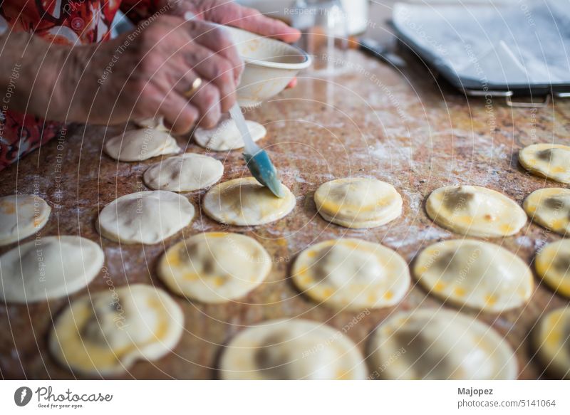 Close up of human hand preparing puff pastry damplings flour culture preparation aged woman appetizer background brush closeup coating cooking copy space