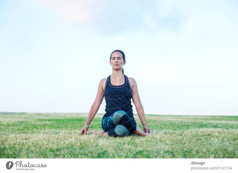 A Young woman doing yoga exercise outdoor Adult Balance Barefoot Beautiful People Casual Clothing Caucasian Ethnicity Concepts Exercising Females Front View