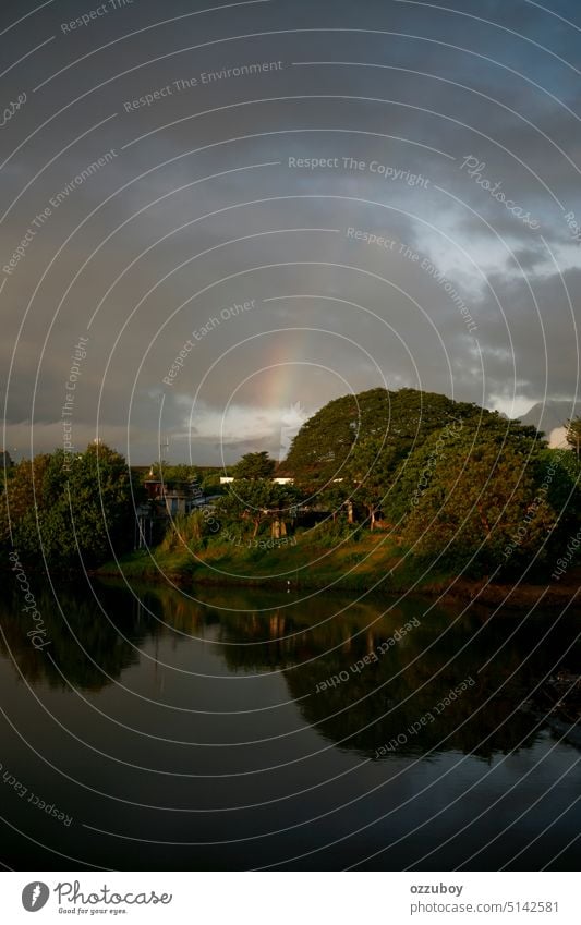 stormy cloud with rainbow in the side of the river nature sky landscape outdoor water scenic blue weather fall travel green background cloudscape day