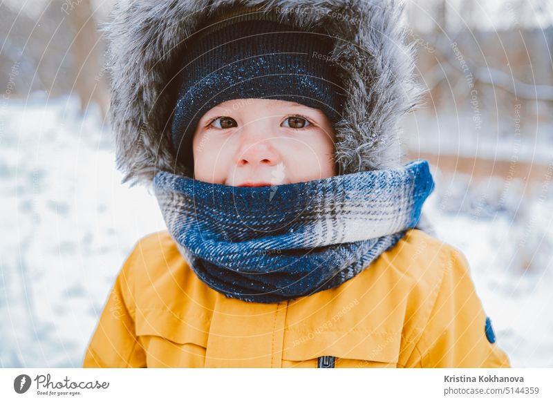 Cute portrait of little baby in winter hat on snowy forest background. Son, toddler child concept. person boy childhood fun joy family happy white cheerful