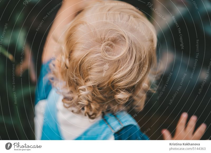 Head of small child from behind. Blond curly hair. person baby girl portrait happiness female happy infant family young childhood cute lifestyle background