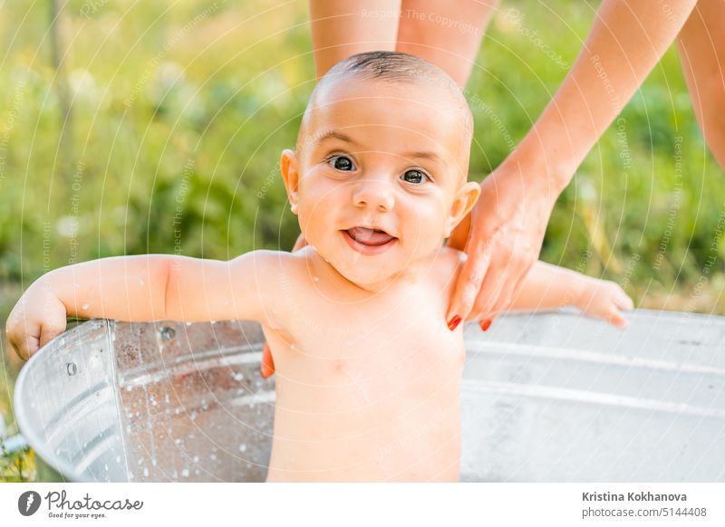 Cute little smiling baby boy portrait in milk bath. Healthy lifestyle. child in summer garden, nature concept. sunflowers clean bathtub childhood beauty