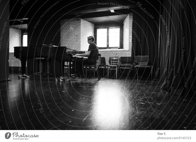 a man plays the grand piano Piano Grand piano Music Play piano Keyboard instrument Musical instrument Make music Practice Musician Interior shot Art Man b/w bnw