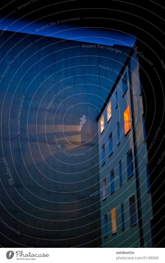 Light in the backyard Evening Old building on the outside Fire wall Dark lit Facade Window mystery House (Residential Structure) Sky Sky blue rear building