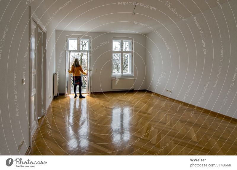 A woman inspects her new apartment and opens the door to the balcony relocation move in Woman Future Flat (apartment) Empty retract move house visit commit