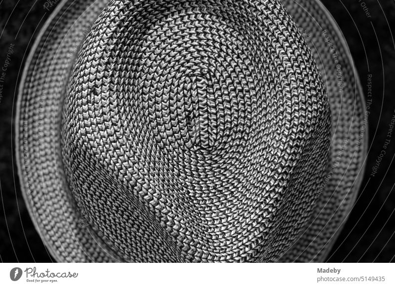 Fashion hat with rough texture in a shop window on a promenade in Knokke-Heist on the North Sea near Bruges in West Flanders, Belgium in classic black and white