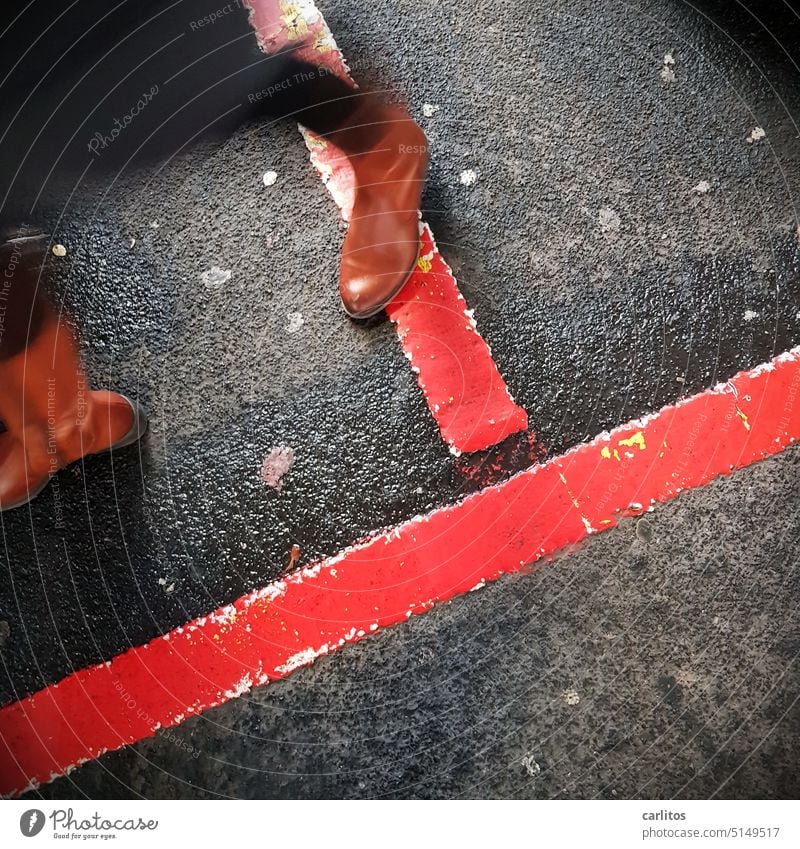 Boundaries | Woman crosses red lines feet Footwear Boots Going Movement Walking Line Red Border mark Asphalt Feet Legs Human being Street Lanes & trails Shadow