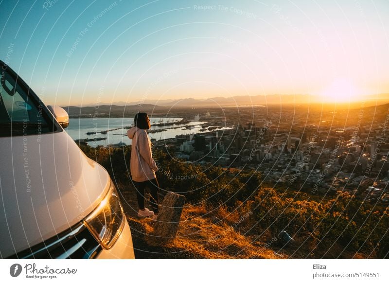 Woman standing on a viewpoint watching the sunrise over Cape Town Sunrise travel Adventure van Vacation & Travel Freedom Trip vantage point Far-off places Sky