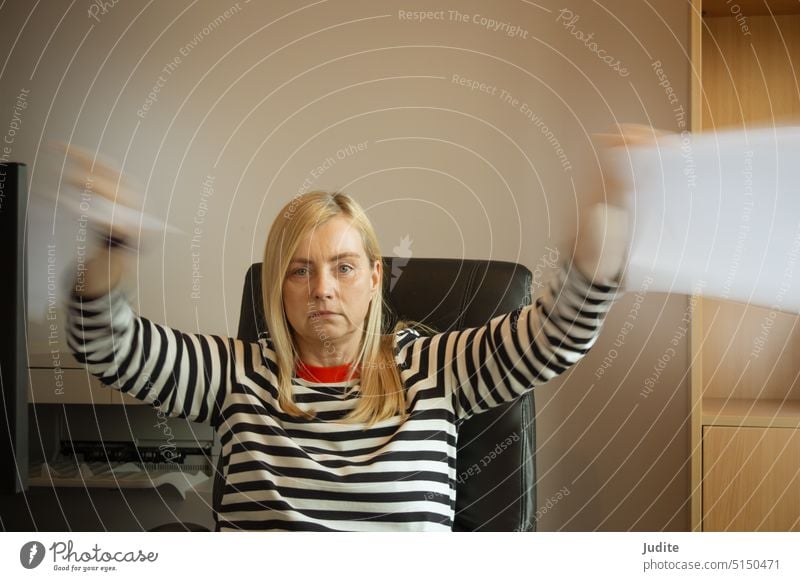 Shocked woman among papers in the office amused amusement attractive boss business businessman businesswoman computer confident corporate desk employee