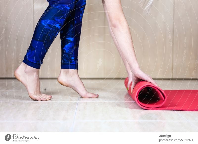 Close up of a woman hands is rolling up exercise mat and preparing to doing yoga. person sport fitness lifestyle gym pilates female training health girl