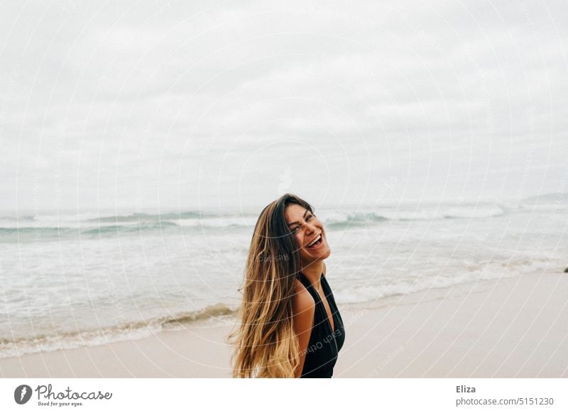 Laughing woman in black swimsuit on beach Woman Beach Swimsuit Laughter Joy Good mood omitted Happiness Joie de vivre (Vitality) Ocean Positive Human being