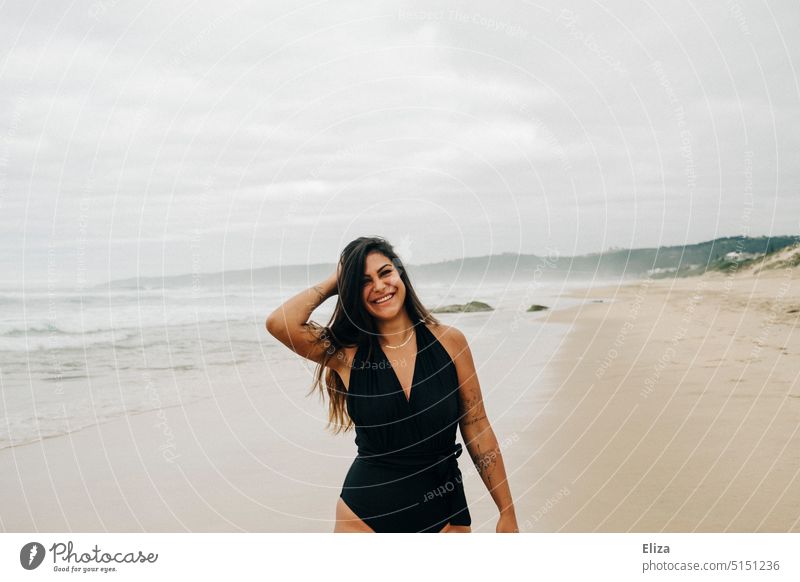 Laughing woman in black swimsuit on beach Woman Beach Swimsuit Laughter Joy Good mood omitted Happiness Joie de vivre (Vitality) Ocean Positive Human being