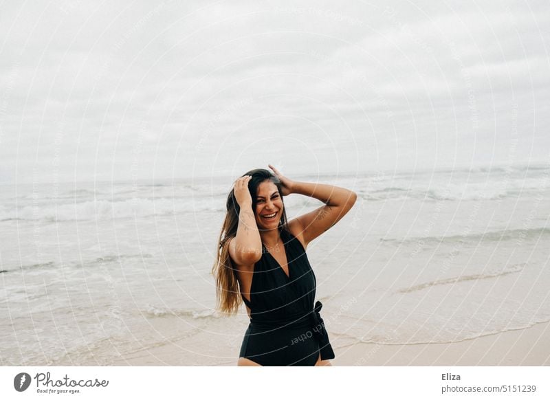 Laughing woman in black swimsuit on beach Woman Beach Swimsuit Laughter Joy Good mood omitted Happiness Joie de vivre (Vitality) Ocean Positive Human being