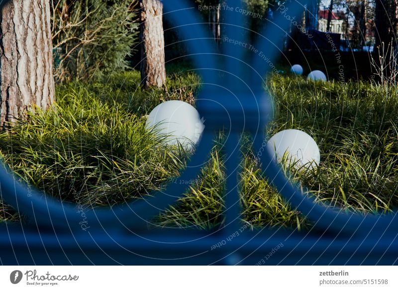 Ball lamps behind a fence Berlin Dahlem Relaxation Recreation area Green Park To go for a walk trunk surrounding area Fence Metalware Iron wrought-iron Sphere