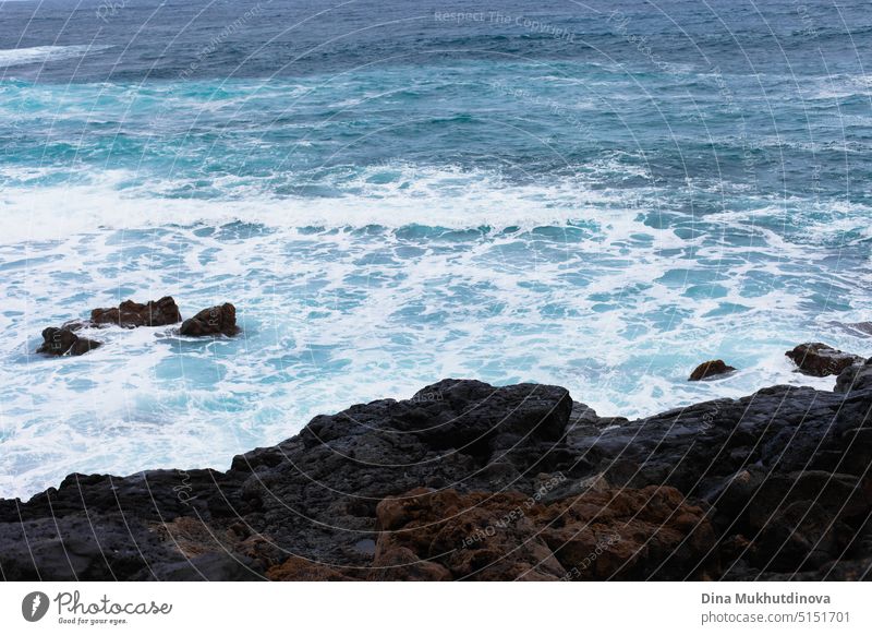 Ocean view landscape with strong waves. Blue color palette. Surfing spot with big waves. Weather conditions and climate change. Vacation at the beach horizontal backdrop.