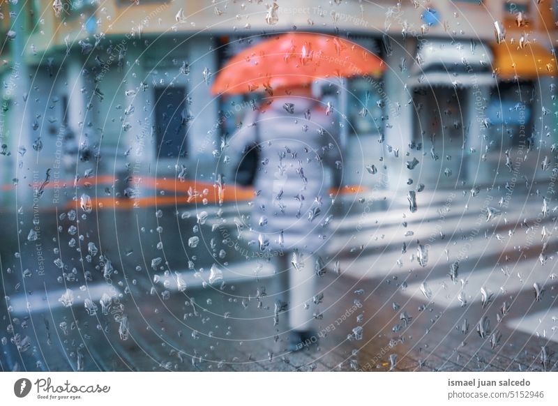 woman with an umbrella in rainy days in wintertime, bilbao, spain people person pedestrian raining rainy season water drops street city urban basque country