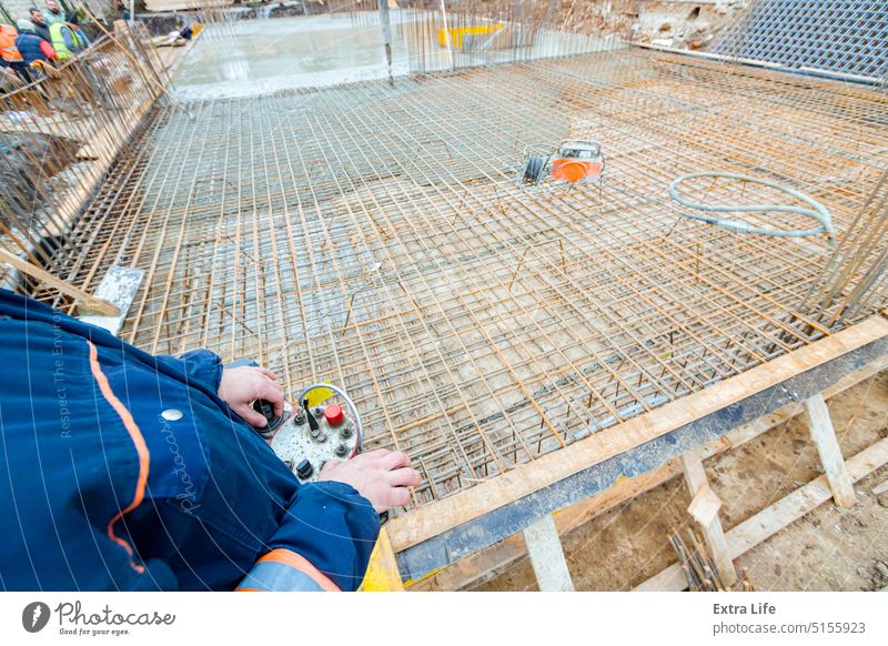 Worker is holding remote, wireless, control for concrete pump at building site Activity Adhere Arm Base Building Site Casting Cement Civil Engineering Command