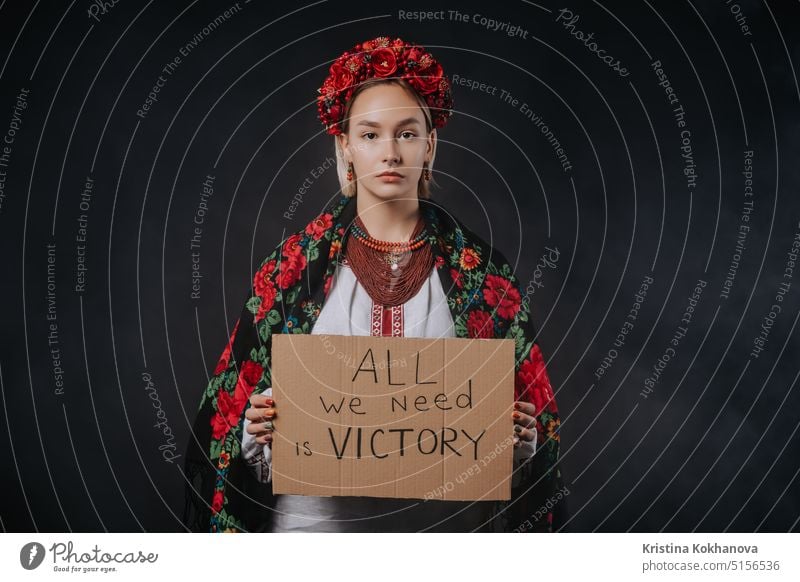 Ukrainian woman with cardboard All we need is victory on black background. Ukraine protest ukrainian demonstration flag politics freedom political stop symbol